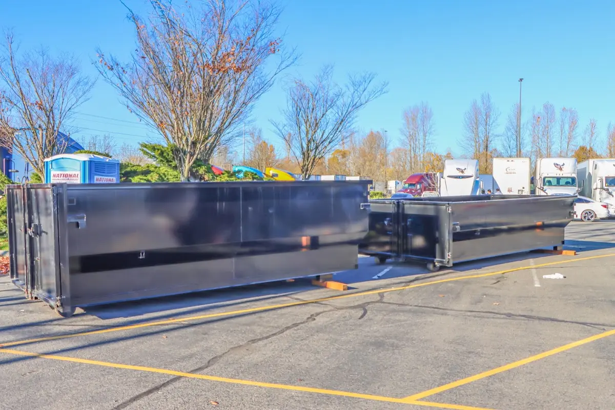 Professional dumpster rental service with roll-off container on residential driveway in Pottstown